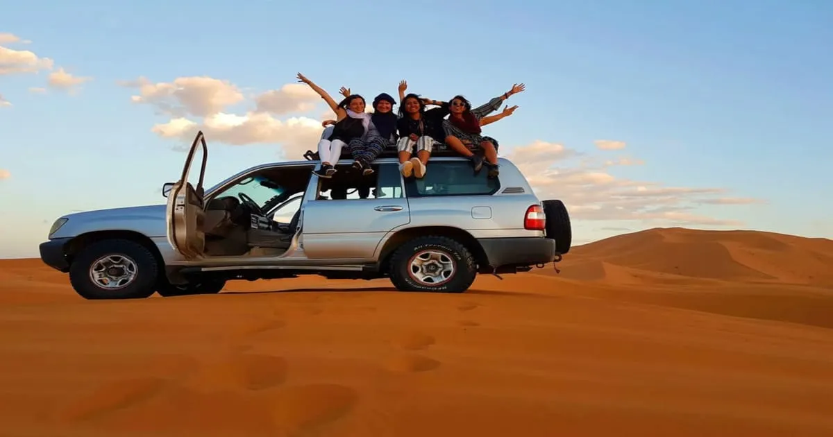 4x4 vehicle crossing the Moroccan desert at sunset