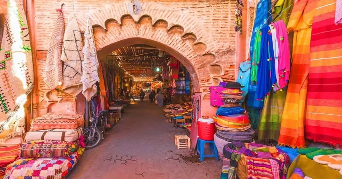 Authentic negotiation scene in souk, merchant and customer discussing in front of colorful carpets, haggling gestures, animated traditional market atmosphere