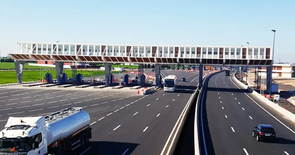 Modern toll plaza on Morocco's A1 autoroute with electronic payment lanes and signage