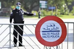 Typical police checkpoint on Morocco roads with officer and control sign