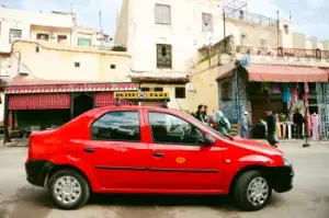 Red petit taxi Rabat Morocco train station transport