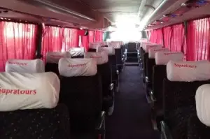 Comfortable Supratours bus interior with reclining seats for Marrakech to Essaouira route
